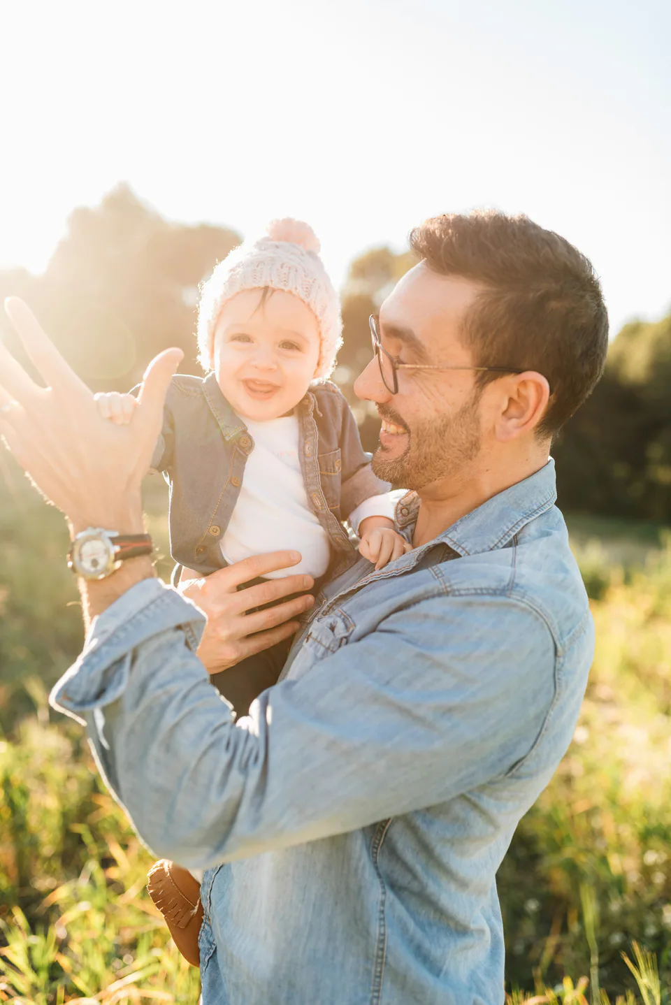 Father holding his young child outdoors